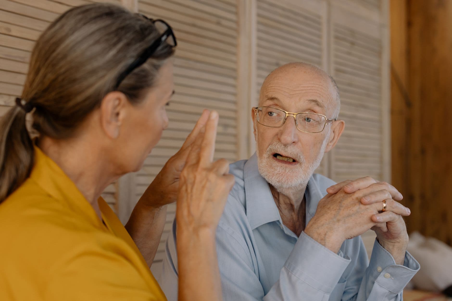 Older couple talking together indoors