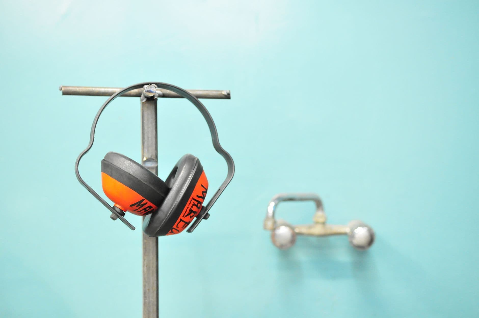Hearing protection earmuffs hanging in a workshop