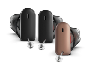 Three discreet behind-the-ear (BTE) hearing aids in black and bronze.